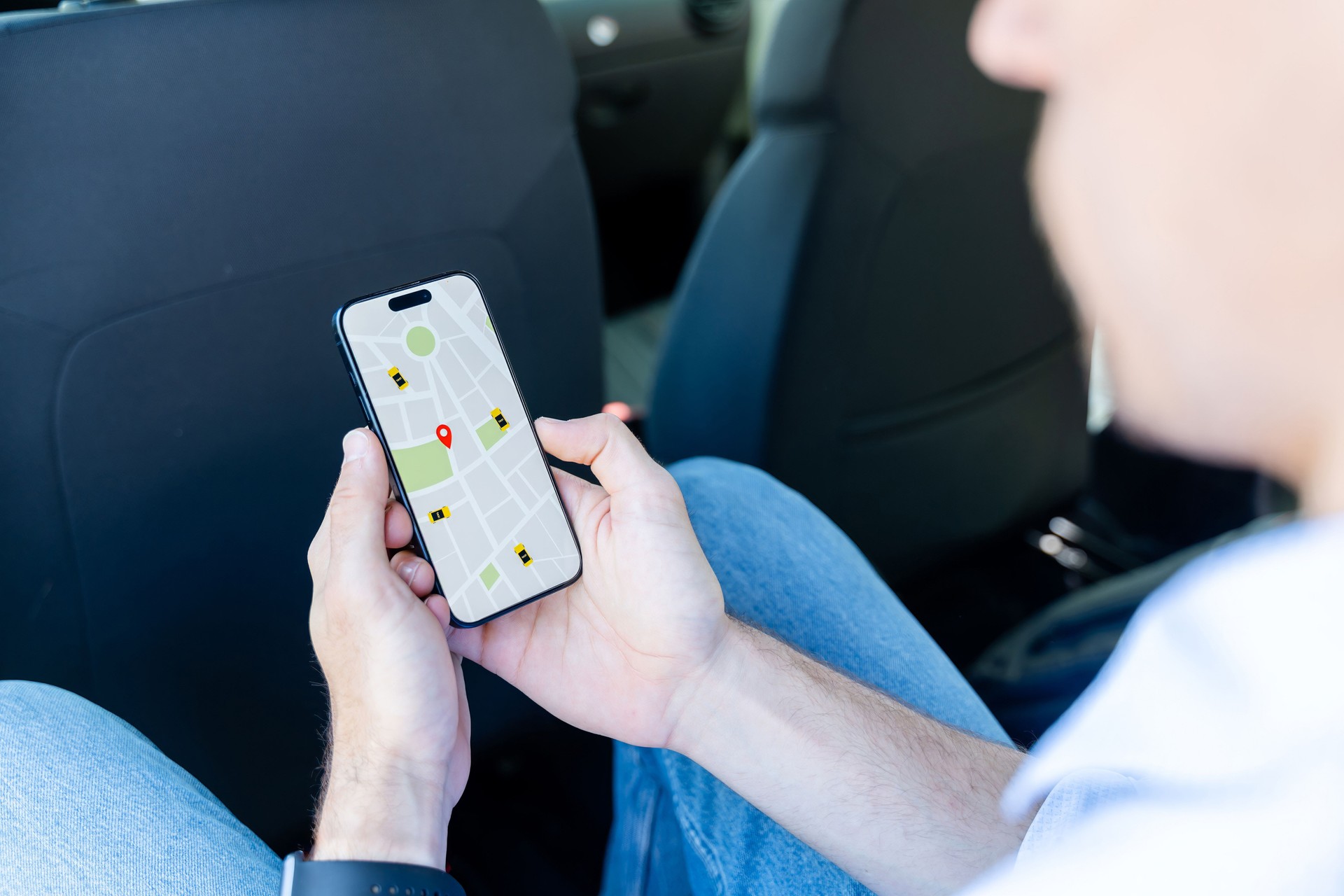 Passenger using ride hailing app on smartphone